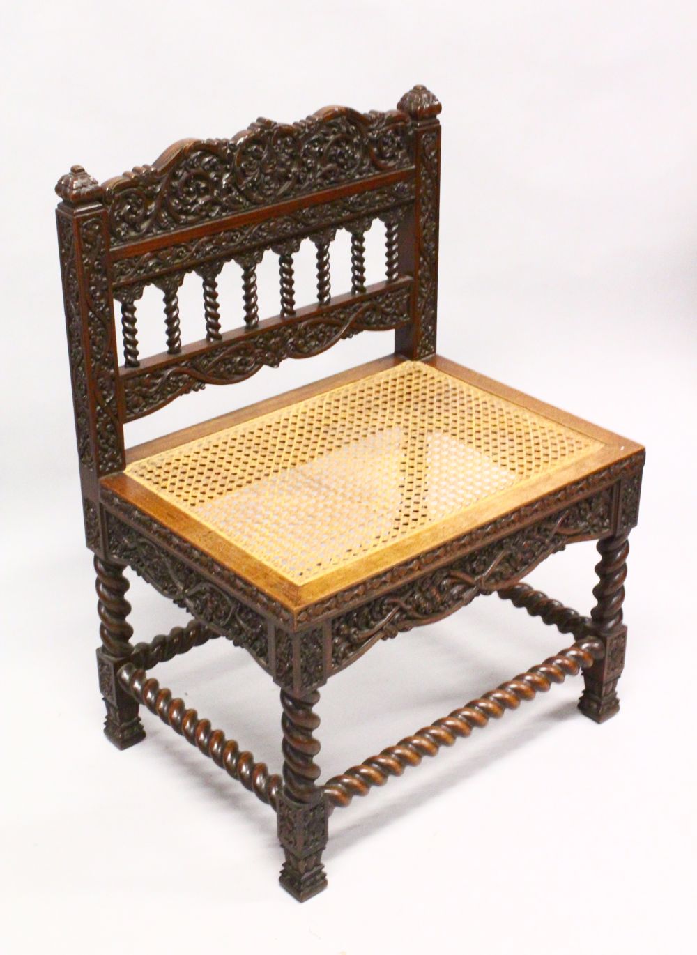 AN 18TH / 19TH CENTURY CEYLONESE CARVED ROSEWOOD CHAIR, with carved panels and wicker woven seat,