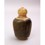 A 19TH CENTURY CHINESE CARVED HORN SNUFF BOTTLE, with gilt calligraphy and landscapes, 8cm.