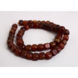 A SET OF 19TH CENTURY CHINESE SQUARE FORM RHINO HORN BEAD NECKLACE, Comprising 54 square beads,