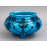 A GOOD KASHAN TURQUOISE POTTERY BOWL, stood on four feet, with black painted decoration of