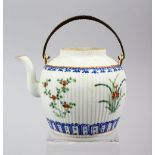 A 19TH CENTURY CHINESE FAMILLE ROSE PORCELAIN RIBBED TEAPOT, with floral decoration, 12cm high x