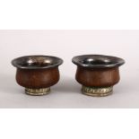 A GOOD PAIR OF 19TH CENTURY TIBETAN CARVED WOOD AND WHITE METAL WINE CUPS, both with white metal