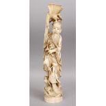 A JAPANESE MEIJI PERIOD CARVED IVORY FIGURE OF A MAN WITH DRAGON AND PHOENIX, The base with a red