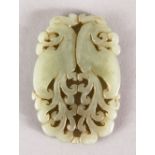 A GOOD 19TH / 20TH CENTURY CHINESE CARVED CELADON JADE PENDANT OF TWO PEACOCKS, two opposing