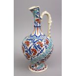 A GOOD POTTERY FLORAL DECORATED EWER FOR THE ISLAMIC MARkET, 35cm