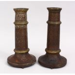 A PAIR OF 19TH CENTURY PERSIAN QAJAR TORCH STANDS / CANDLESTICKS, decorated with formal foliage