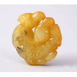 A GOOD CHINESE CARVED JADE ROUNDEL OF A CHICKEN AND TWO CHICKS, 5cm.