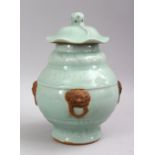 A CHINESE CELADON LONGQUAN PORCELAIN GINGER JAR & COVER, decorated with four moulded lion handles.