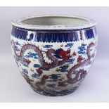 A LARGE 19TH / 20TH CENTURY CHINESE BLUE, WHITE & IRON RED PORCELAIN JARDINIERE, the body