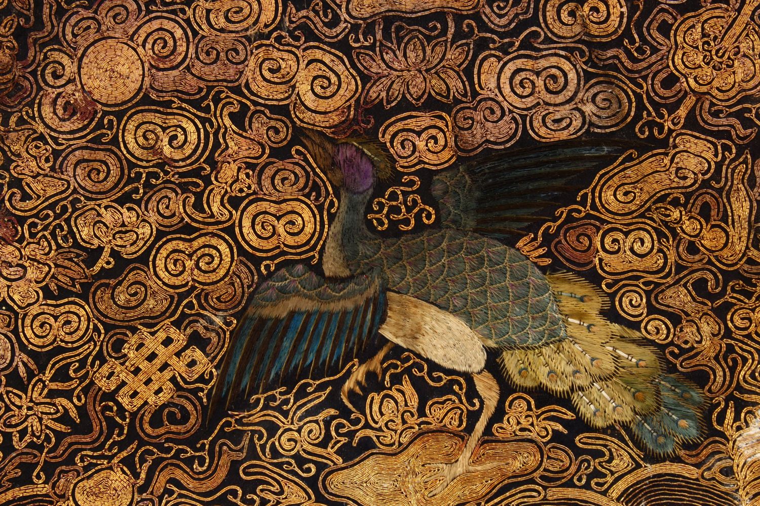 A CHINESE EMBROIDERED TEXTILE PANEL, depicting phoenix birds in landscapes with waves, mounted to - Image 2 of 2