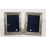 A PAIR OF SILVER UPRIGHT PHOTOGRAPH FRAMES with reeded sides. 7ins x 5ins.