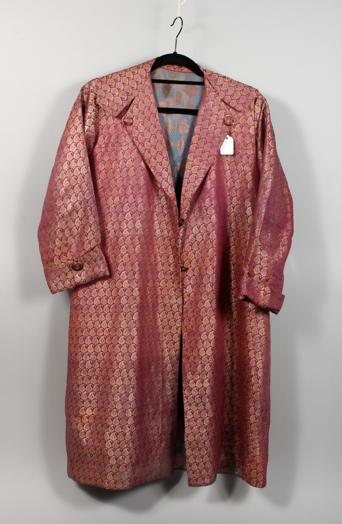 A GOOD INDIAN HOUSECOAT, purple ground with allover gilt thread Boteh design. 3ft 4ins.