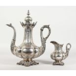 A SUPERB CONTINENTAL SILVER COFFEE POT AND MILK JUG, possibly GERMAN, with engraved body, cast spout