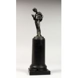 A SMALL BRONZE OF NARCISSUS. 4.5ins high, on a wooden plinth, 9.5ins overall