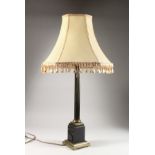 A BRASS CORINTHIAN COLUMN TABLE LAMP, with cream shade. Lamp 22ins high.