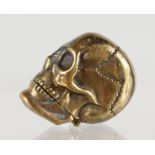 A BRASS SKULL SHAPE VESTA CASE.