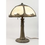 AN ART NOUVEAU STYLE CAST METAL TABLE LAMP, with ornate opaque glass shade, supported on a
