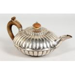 A GEORGE III SILVER CIRCULAR FLUTED TEAPOT AND COVER with wooden knop handle. London 1811. Makers: