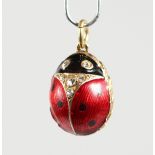 A RUSSIAN RED AND BLACK ENAMEL AND SILVER EGG SHAPE PENDANT.