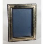 A SILVER PHOTOGRAPH FRAME with reeded edges. 10 high x 7.5ins wide. London 1973.