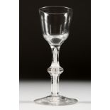 A GEORGIAN WINE GLASS with plain bowl, knop in the stem and white twist. 5.25ins high.