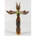 A CARVED OAK AND PAINTED FOLK ART THUNDERBIRD TOTEM POLE. 10ins long.