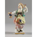 A SMALL MEISSEN PORCELAIN FIGURE OF A YOUNG GIRL carrying grapes. Cross swords mark in blue. 4ins