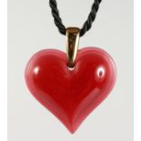 A RED LALIQUE HEART PENDANT.