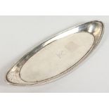 A GEORGE III OVAL SILVER SNUFFER TRAY with bead edge, bird crest. 9ins long. London 1782. Maker