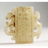 A SMALL CARVED JADE ARCHAIC STYLE PENDANT. 2ins high.
