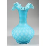 A BLUE OPAQUE GLASS VASE, with frilly edge rim. 9ins high.