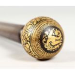 A 19TH CENTURY ROSEWOOD CANE with gold inlaid handle. 34ins long.