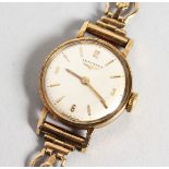 A LADIES' 9CT GOLD LONGINES WRISTWATCH with 9ct gold bracelet, in a box.