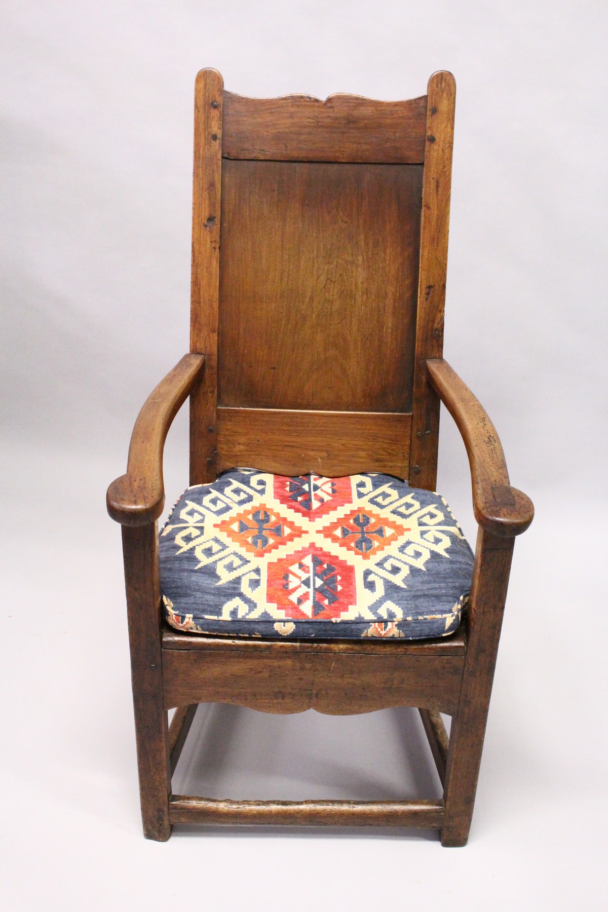 A 17TH / 18TH CENTURY LAMBING CHAIR, possibly fruitwood, with shaped cresting, plain panel back, - Image 2 of 3