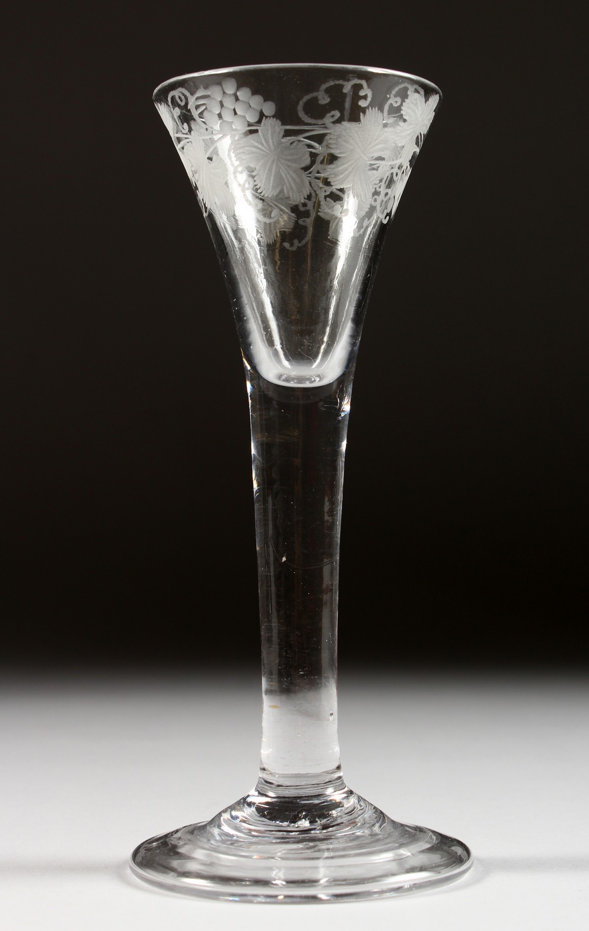 A GEORGIAN WINE GLASS with tapering bowl engraved with fruiting vines, plain stem. 6.5ins high.