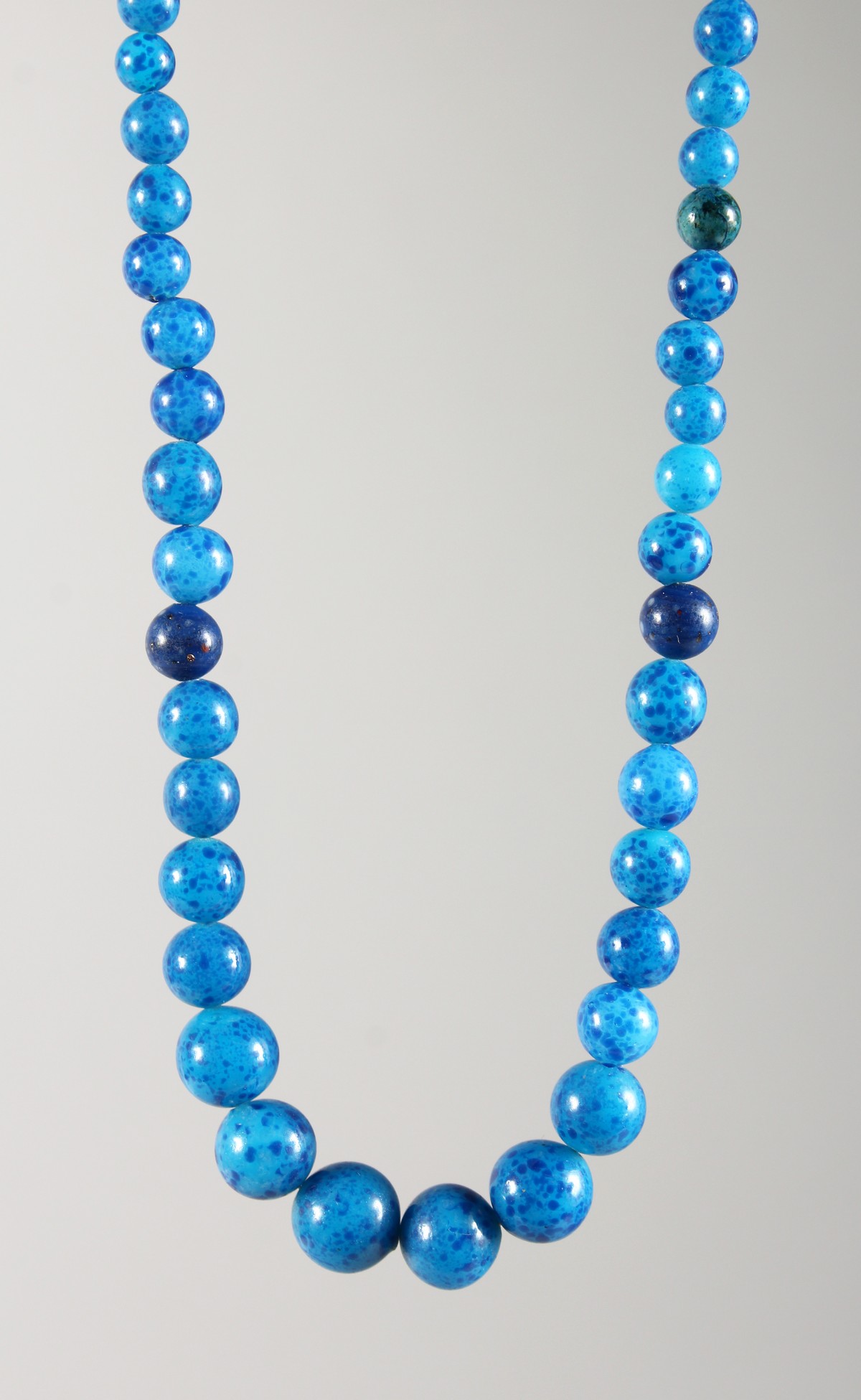 A LAPIS NECKLACE with gold fastener.