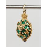 A RUSSIAN GREEN ENAMEL AND SILVER EGG SHAPED PENDANT.