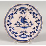 A FAIENCE BLUE AND WHITE PLATE with a crest. 8.5ins diameter.