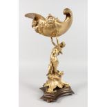 A GILT BRONZE CENTREPIECE, modelled as a lady holding aloft a conch shell. 15.5ins high.