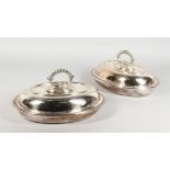 A PAIR OF PLATED OVAL ENTREE DISHES, COVER AND HANDLE, with beaded edges. 11ins wide.