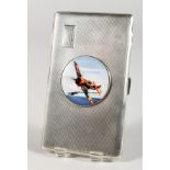 A LARGE ENGINE TURNED SILVER CIGARETTE CASE with a circular enamel plaque of a Spitfire.