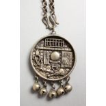 A CHINESE SILVER CIRCULAR PENDANT AND CHAIN. 1.5ins diameter.