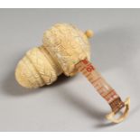 A CARVED BONE ACORN TAPE MEASURE.