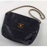 A BLACK CHANEL FOLDING BAG.