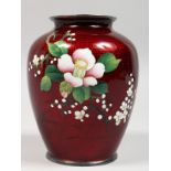A JAPANESE CLOISONNE VASE, red ground decorated with flowers. 6ins high.