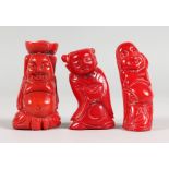THREE CHINESE CARVED CORAL FIGURES. 2.25ins x 2.5ins high.