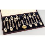 A SUPERB SET OF TWELVE VICTORIAN PIERCED SILVER TEASPOONS, TONGS AND CADDY SPOON in a case. London