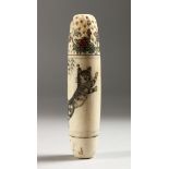 A CARVED BONE NEEDLE AND THIMBLE CASE.