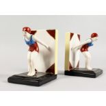 A PAIR OF ART DECO STYLE PORCELAIN BOOK ENDS of female swimmers. 6ins high.