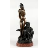 A GOOD LARGE BRONZE GROUP OF AN ARAB SLAVE TRADER SEATED BY A STANDING FEMALE NUDE, on a rouge